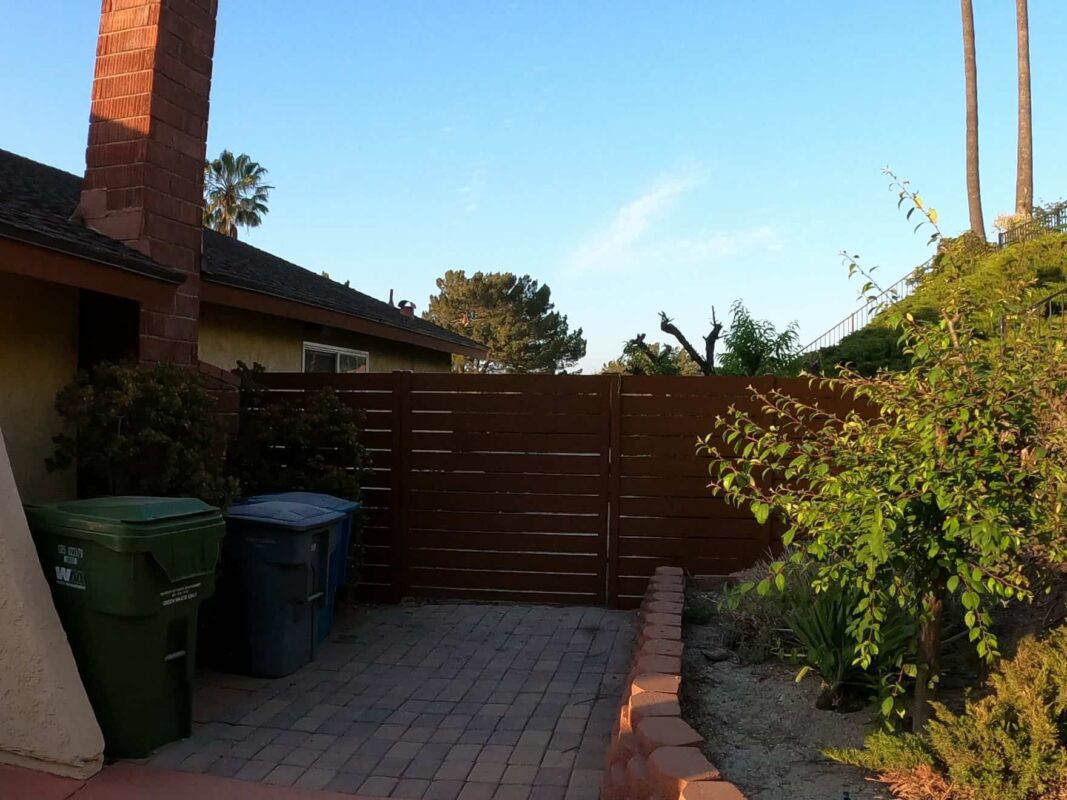 Brown Aluminum fence and pedestrian gate