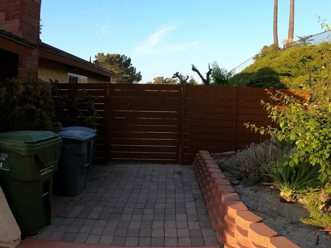 Brown Aluminum fence and pedestrian gate