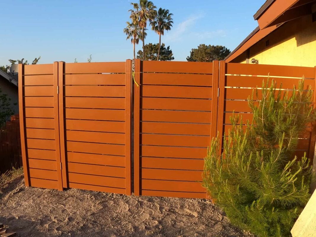 Brown Aluminum fence and pedestrian gate