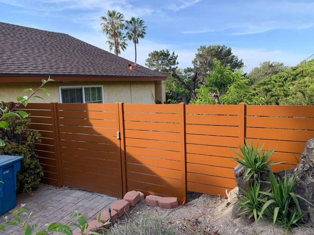 Brown Aluminum fence and pedestrian gate