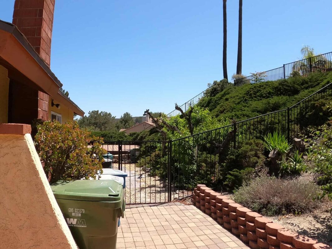 Brown Aluminum fence and pedestrian gate