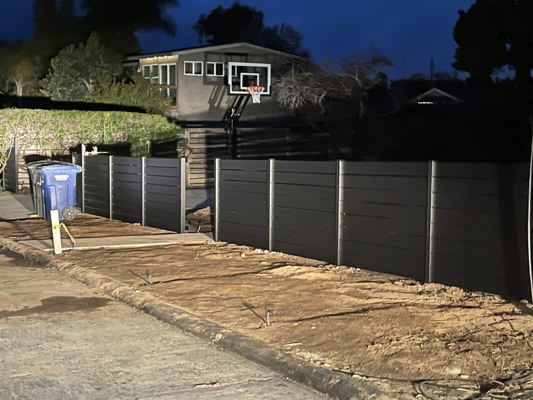 Black Aluminum fence around residential property and driveway