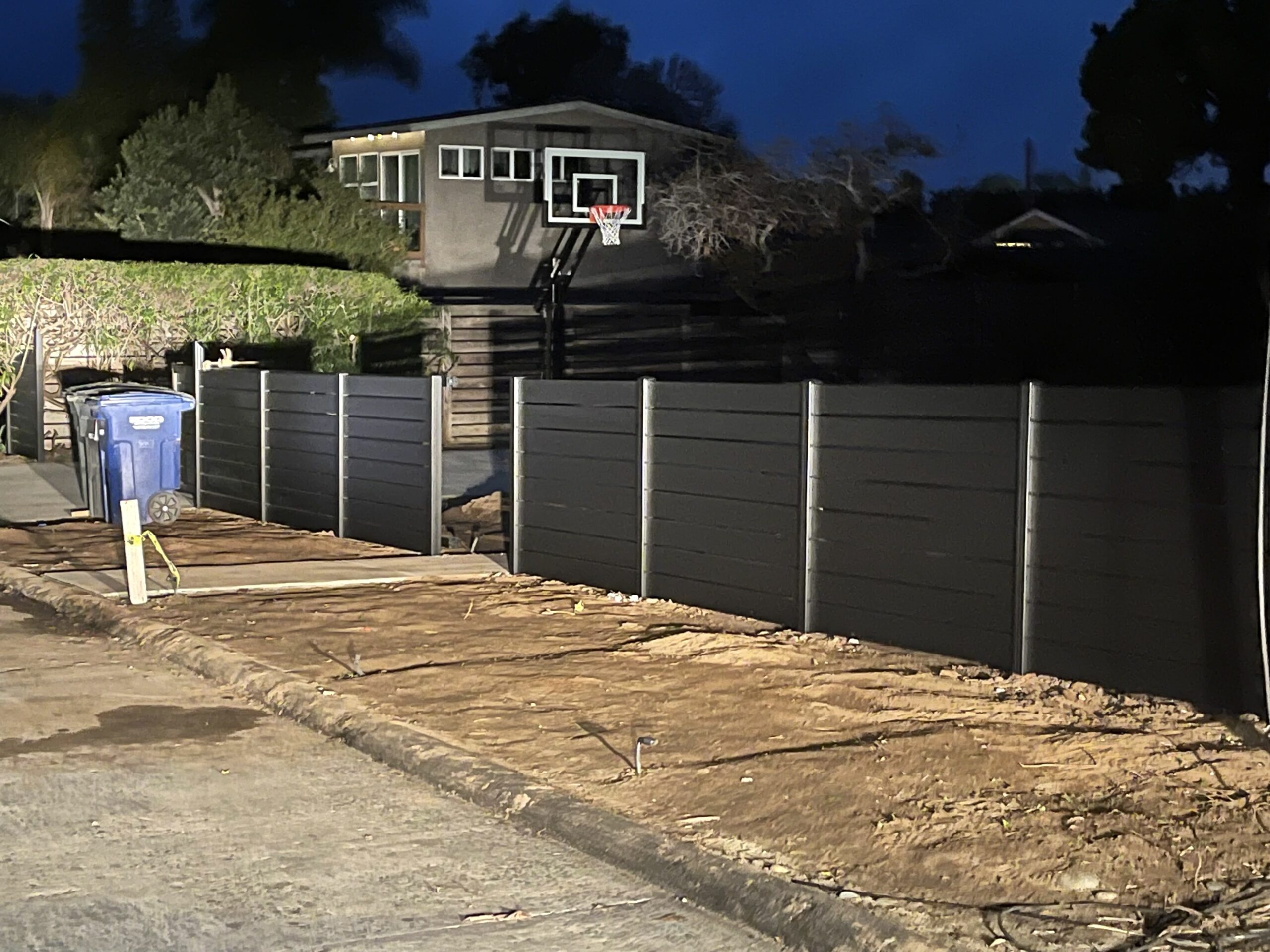 Black Aluminum fence around residential property and driveway
