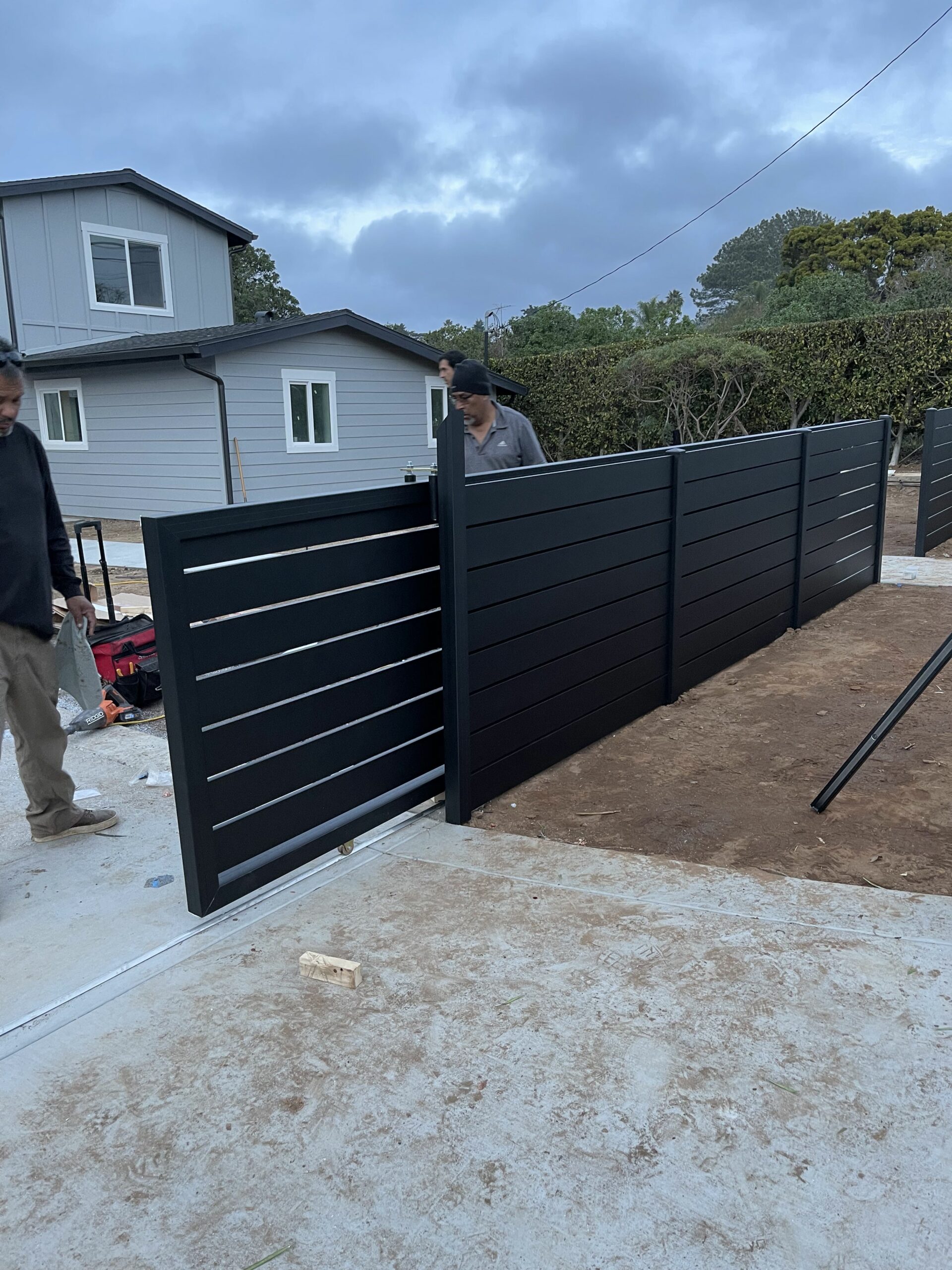 Black Aluminum sliding fence for residential property and driveway