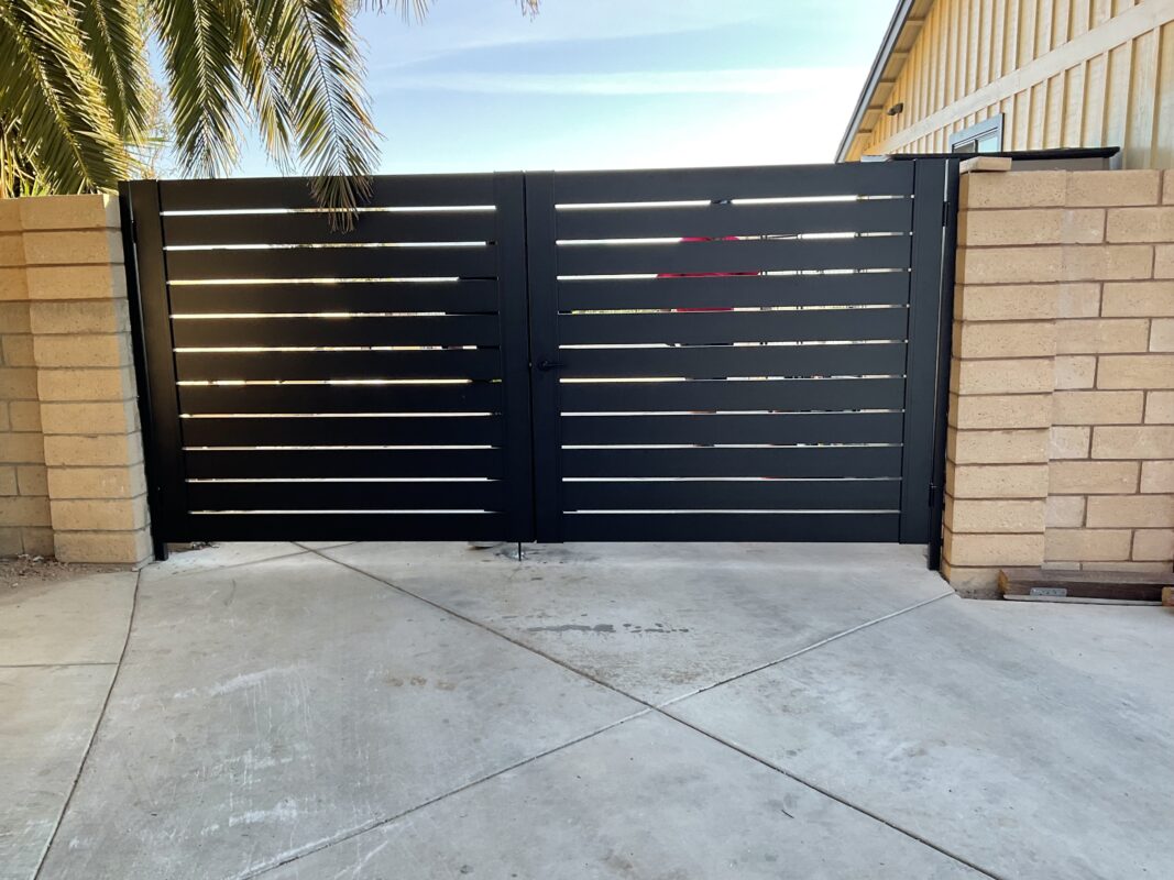 Black Double Swing Gate Installed In Driveway