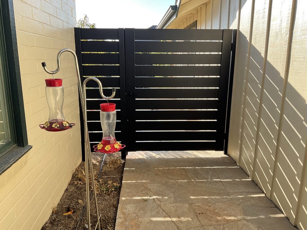 Black Pedestrian Gate Installed With Extra Panel