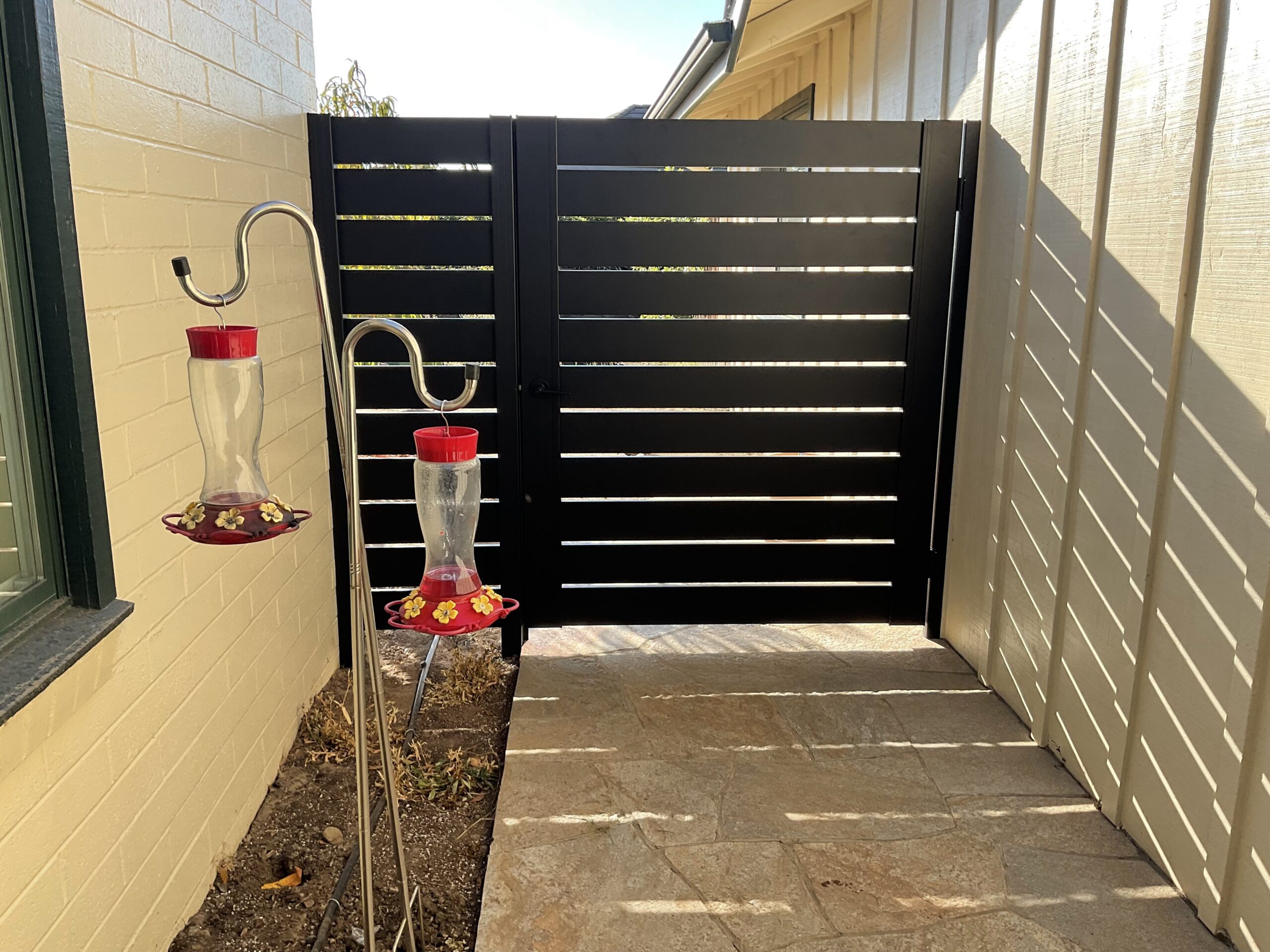Black Pedestrian Gate Installed With Extra Panel