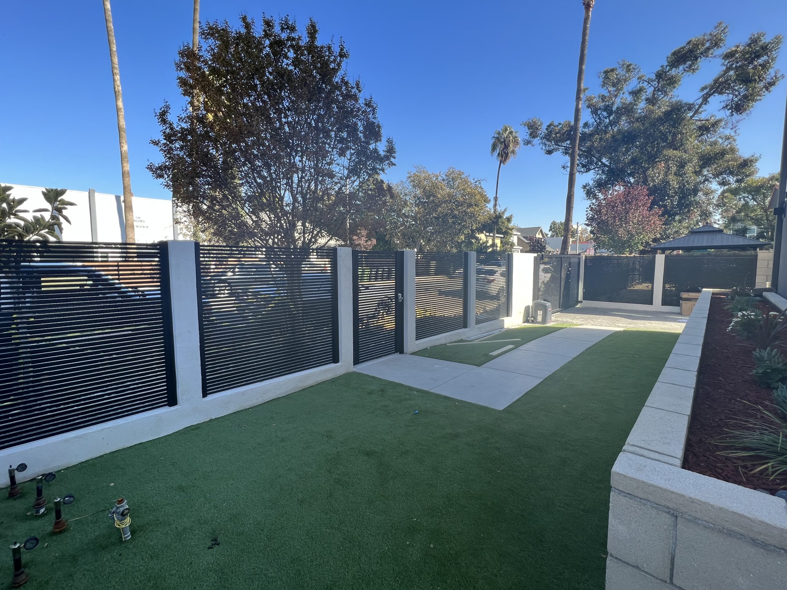 Alumission's San Francisco Style Driveway Gate, Pedestrian Gate, and Fence Panels.