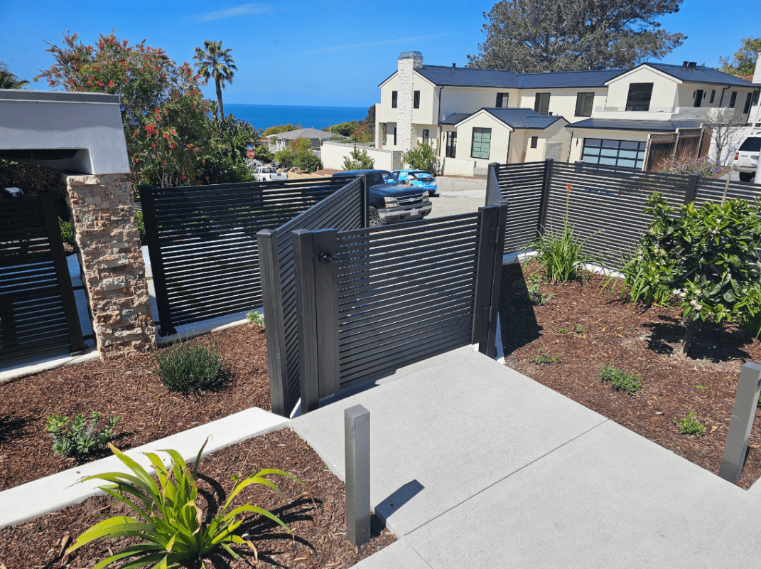 San Francisco Style Bronze Pedestrian Gate and Fence Surrounding Front of Home Overlooking Pacific Ocean.