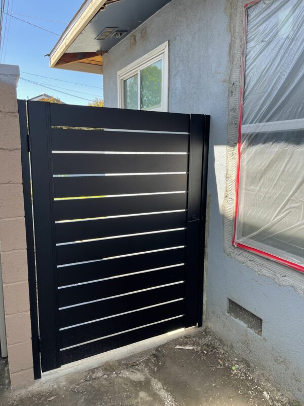Aluminum Pedestrian Gate installed on side of home.
