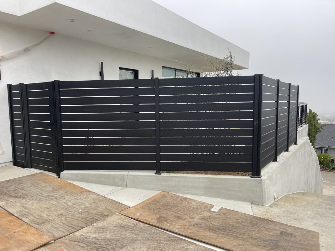 Black Aluminum Panels and Fence installed around home with pedestrian gate
