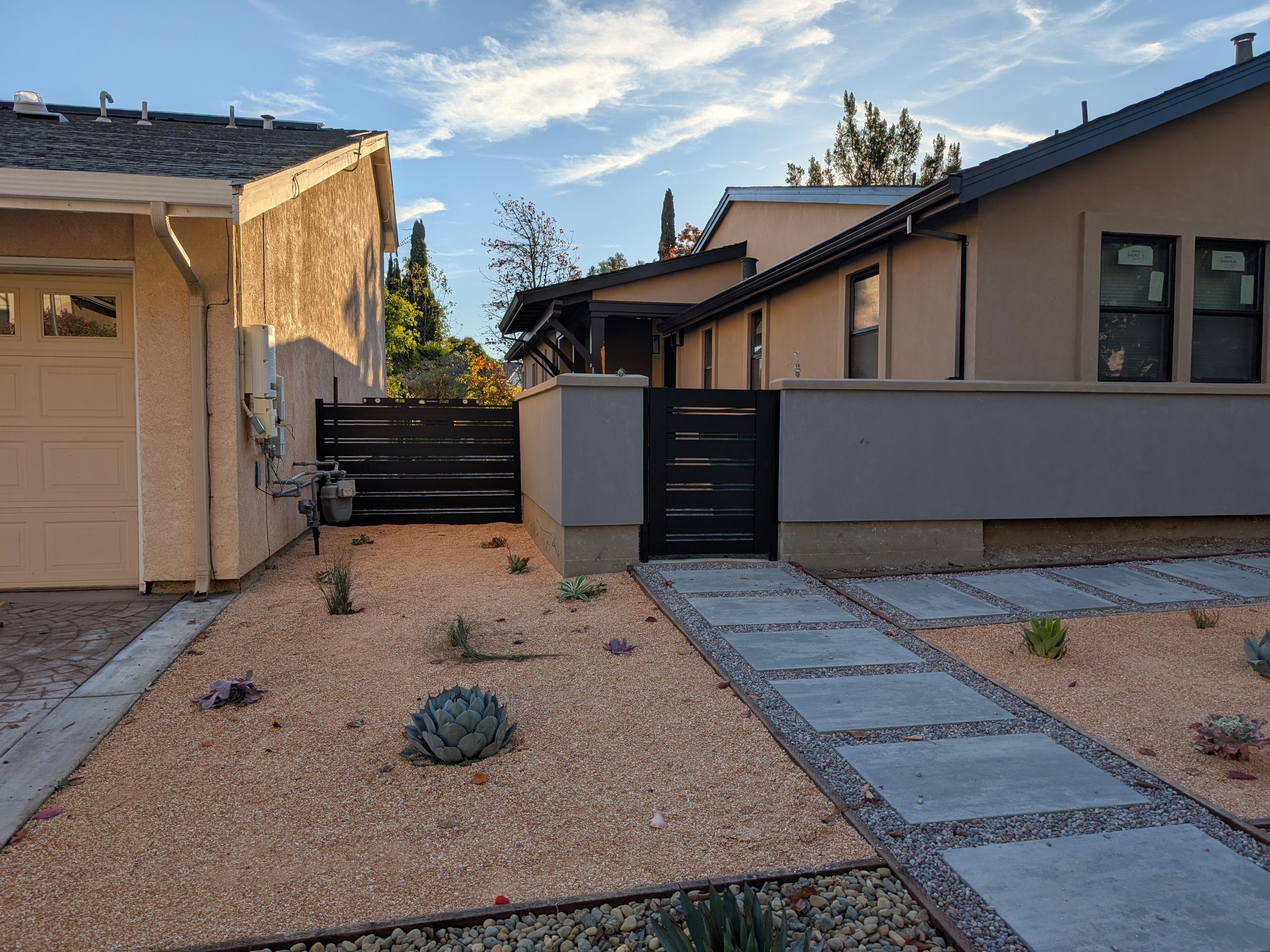 Modern aluminum fence and gate in a landscaped yard in Fremont, CA.