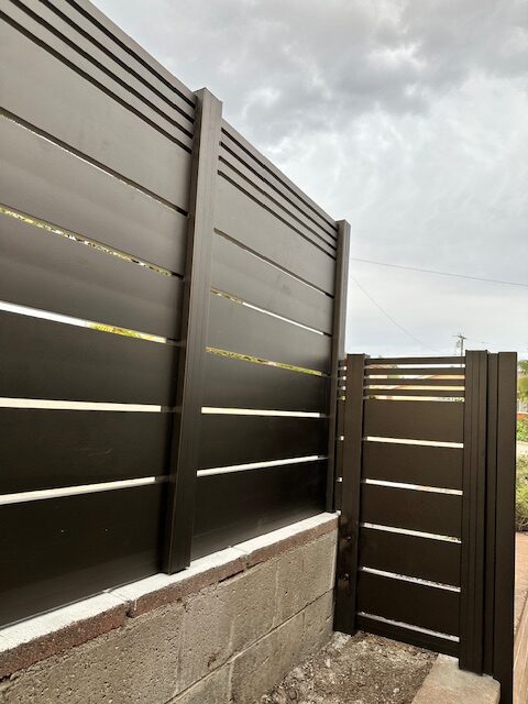 Modern black aluminum fence installation with horizontal slats in Ventura, CA.