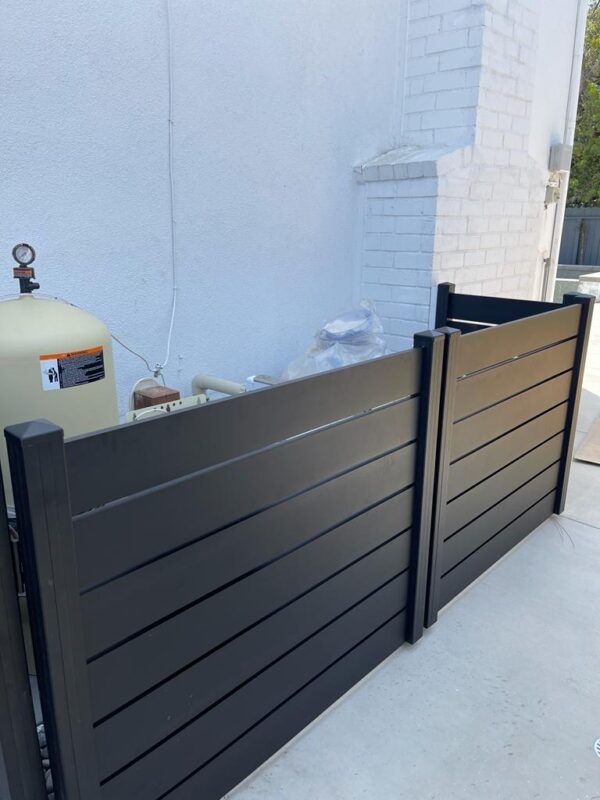 Installed black aluminum fence around pool equipment for stylish protection.