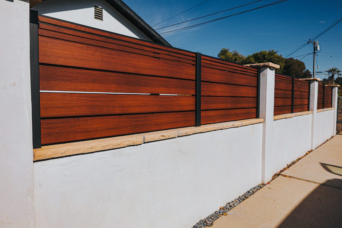 Modern aluminum fence with wood-like finish installed on a property in Santa Barbara.