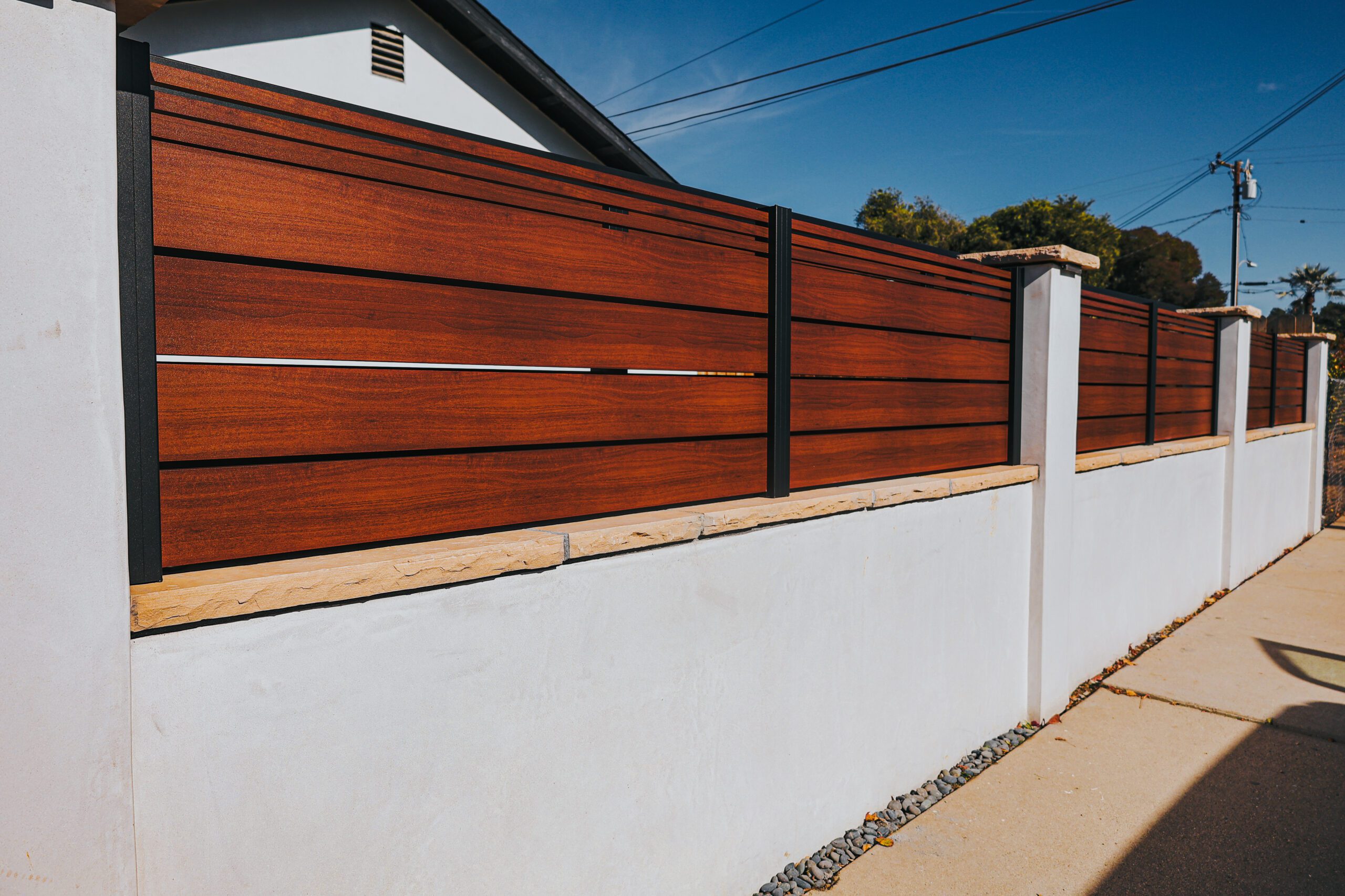Modern aluminum fence with wood-like finish installed on a property in Santa Barbara.