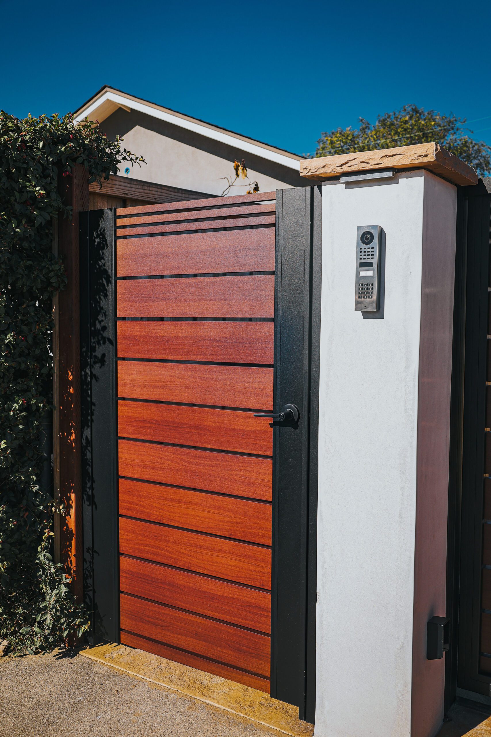 Modern aluminum gate resembling wood in a Santa Barbara installation.