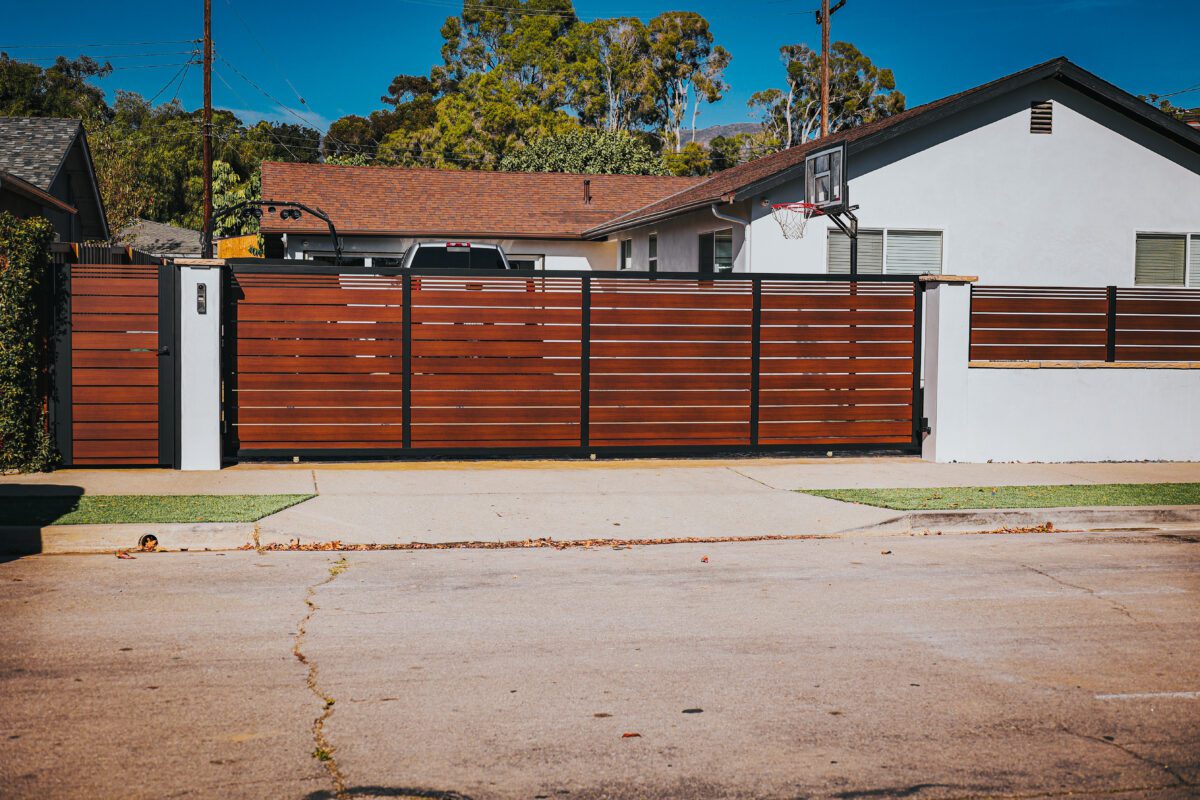 Modern aluminum gate mimicking wood design enhances curb appeal in Santa Barbara.