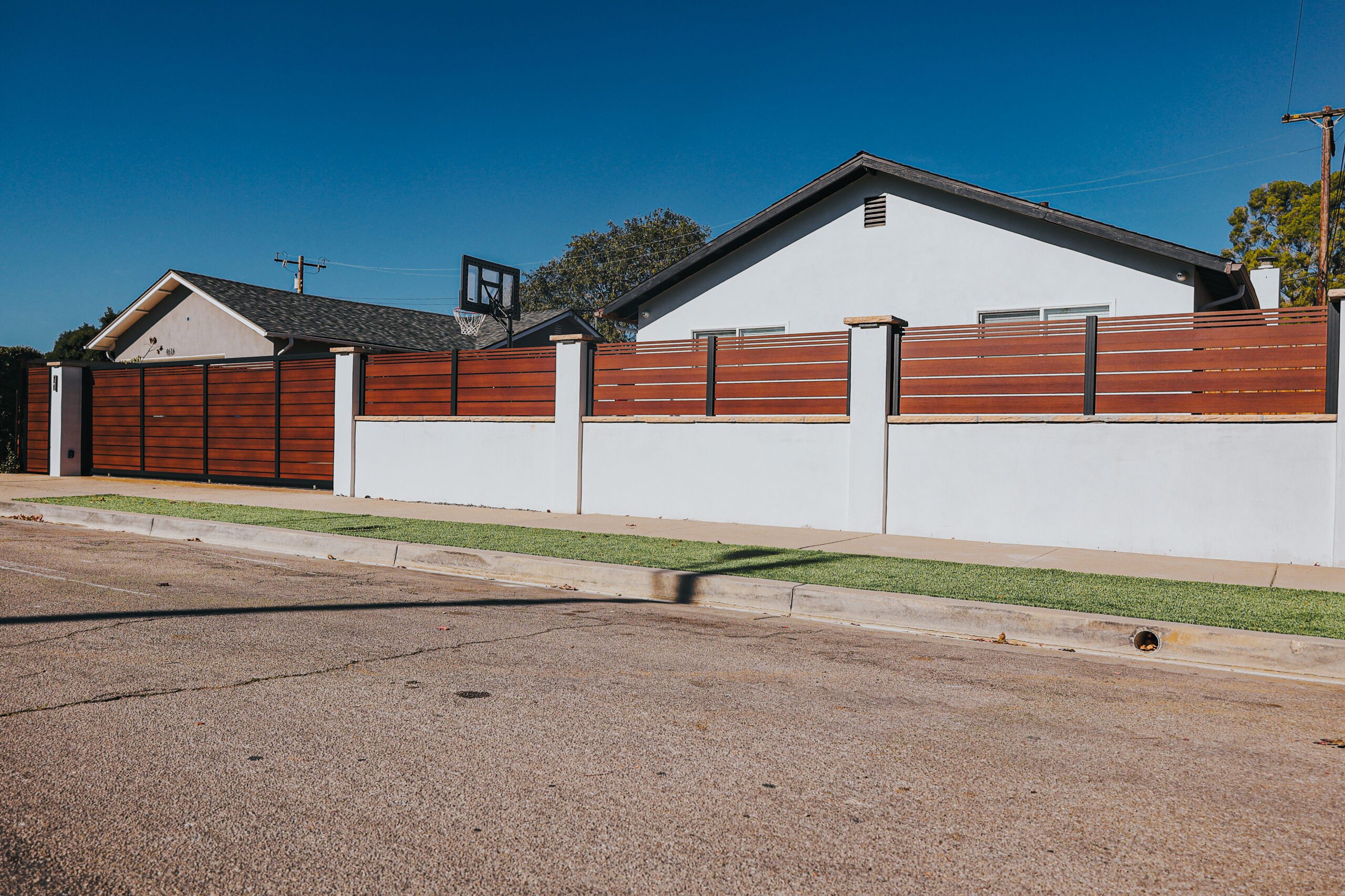 Modern aluminum fence resembling wood, enhancing curb appeal in a Santa Barbara neighborhood.