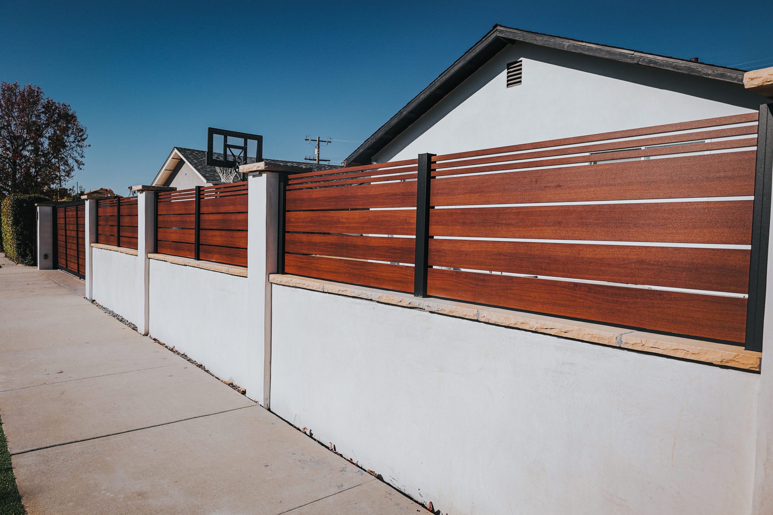 Modern aluminum fence resembling wood, enhancing property aesthetics in Santa Barbara.