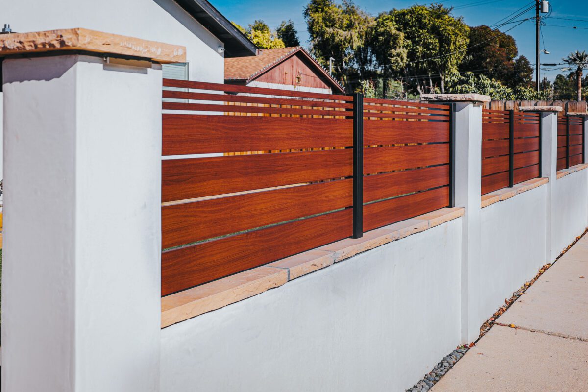 Modern aluminum fence with a wood-like finish, showcasing durability and style.