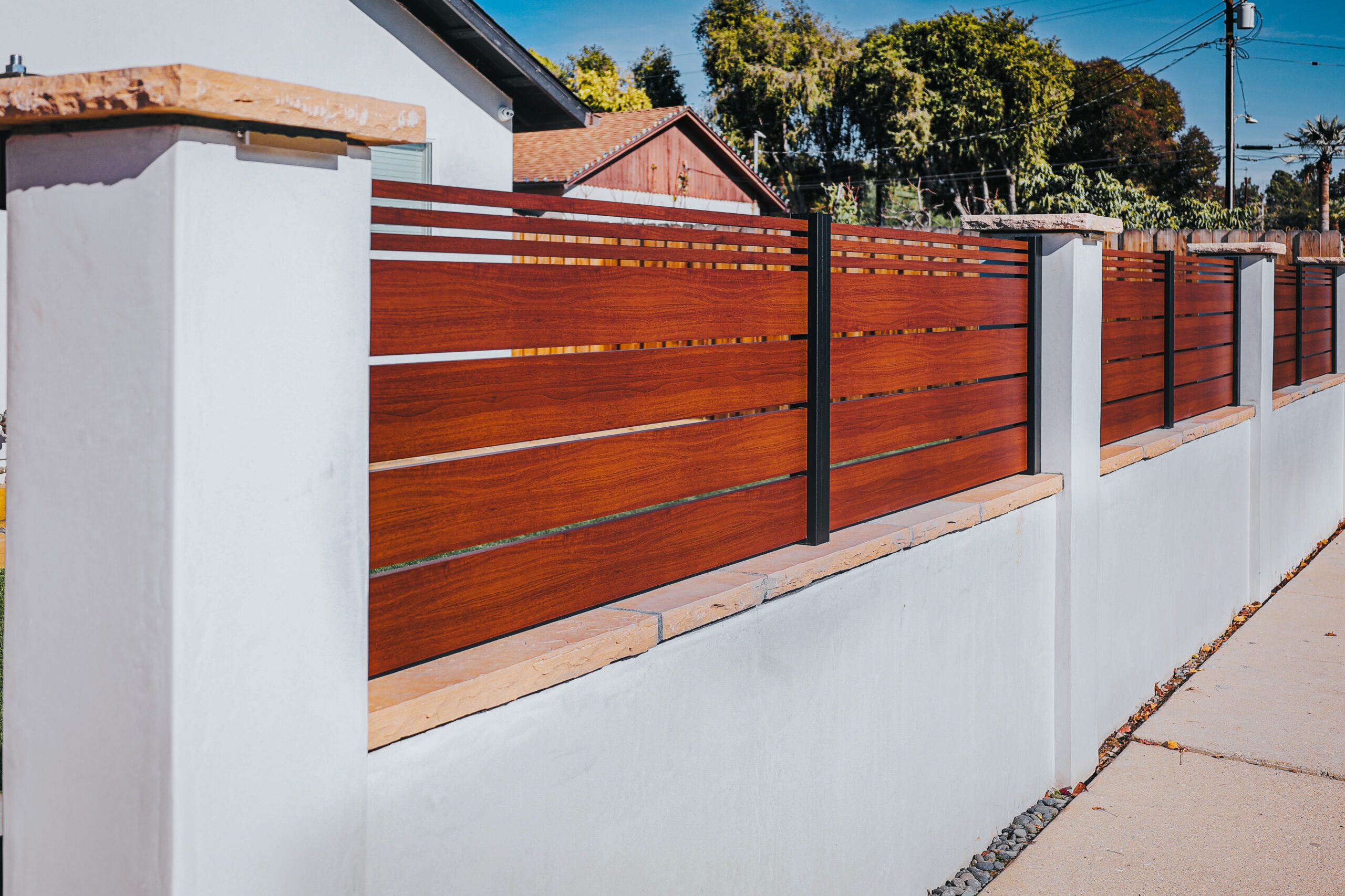 Modern aluminum fence with a wood-like finish, showcasing durability and style.