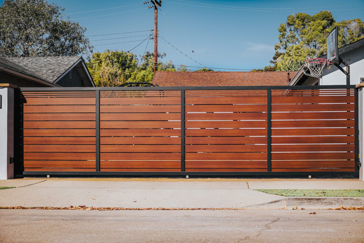 Modern aluminum fence with wood-like appearance, installed in a residential area.