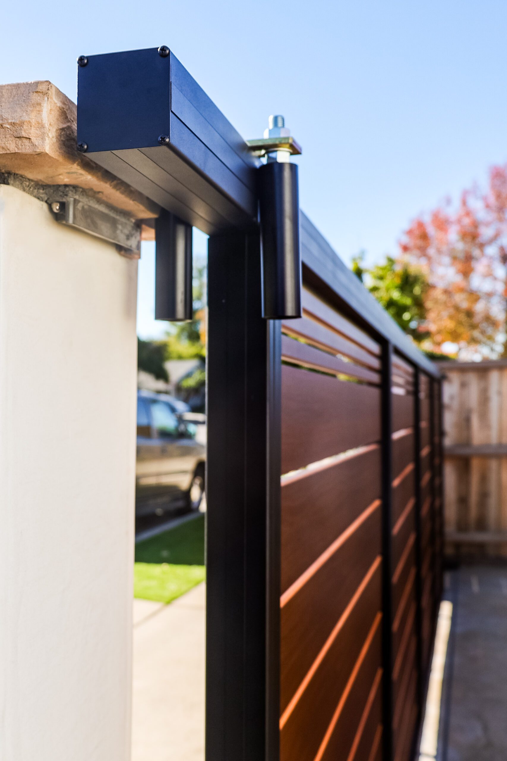 Close-up of a robust aluminum gate installation in Santa Barbara with wooden appearance.