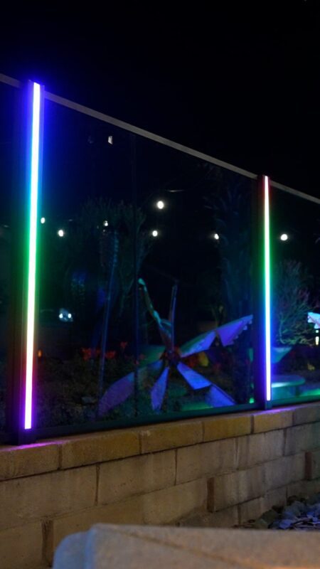 Vibrant LED-lit aluminum fence installation illuminated at night in Rosemead, CA.