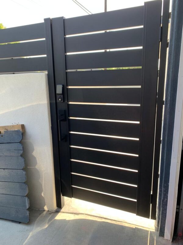 Black aluminum gate installed, showcasing modern design for enhanced privacy.