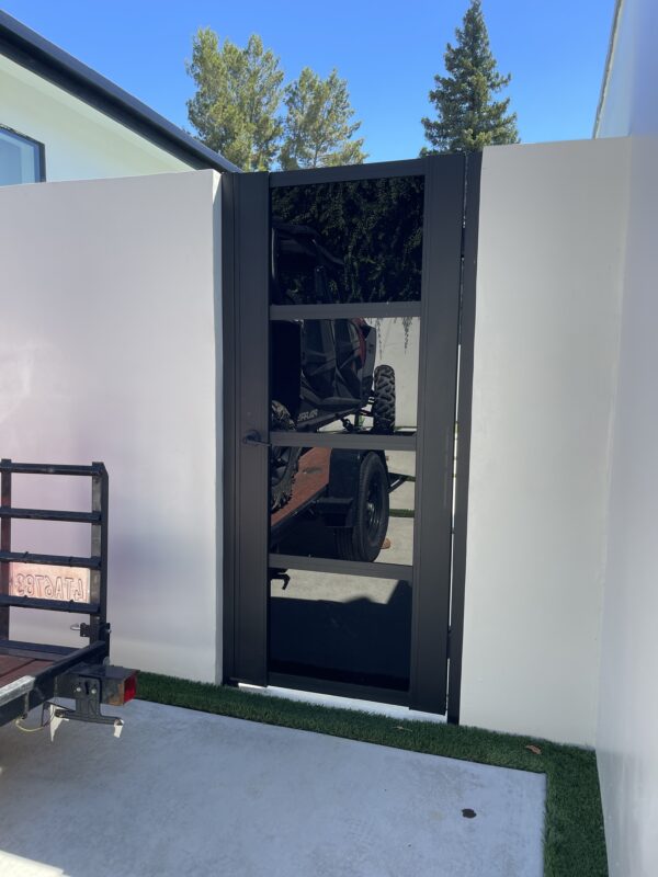 Modern black acrylic gate installation, enhancing property privacy and style.