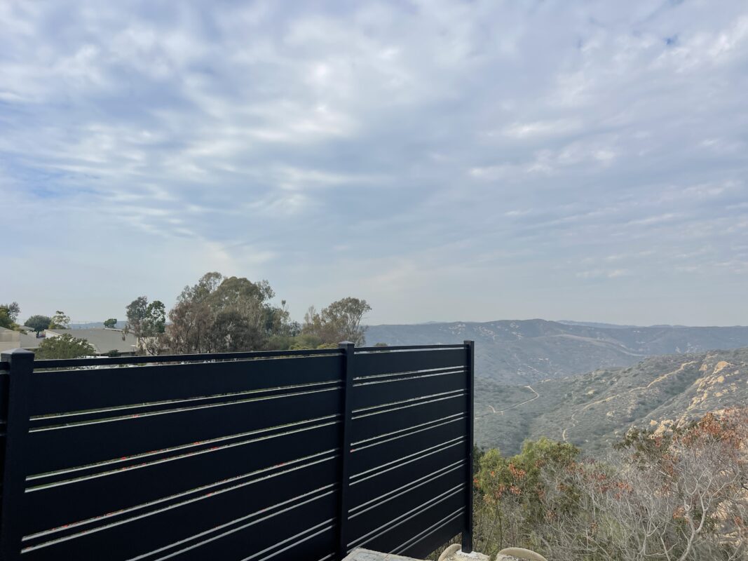 Modern black aluminum fence overlooking a scenic landscape in Laguna Beach.