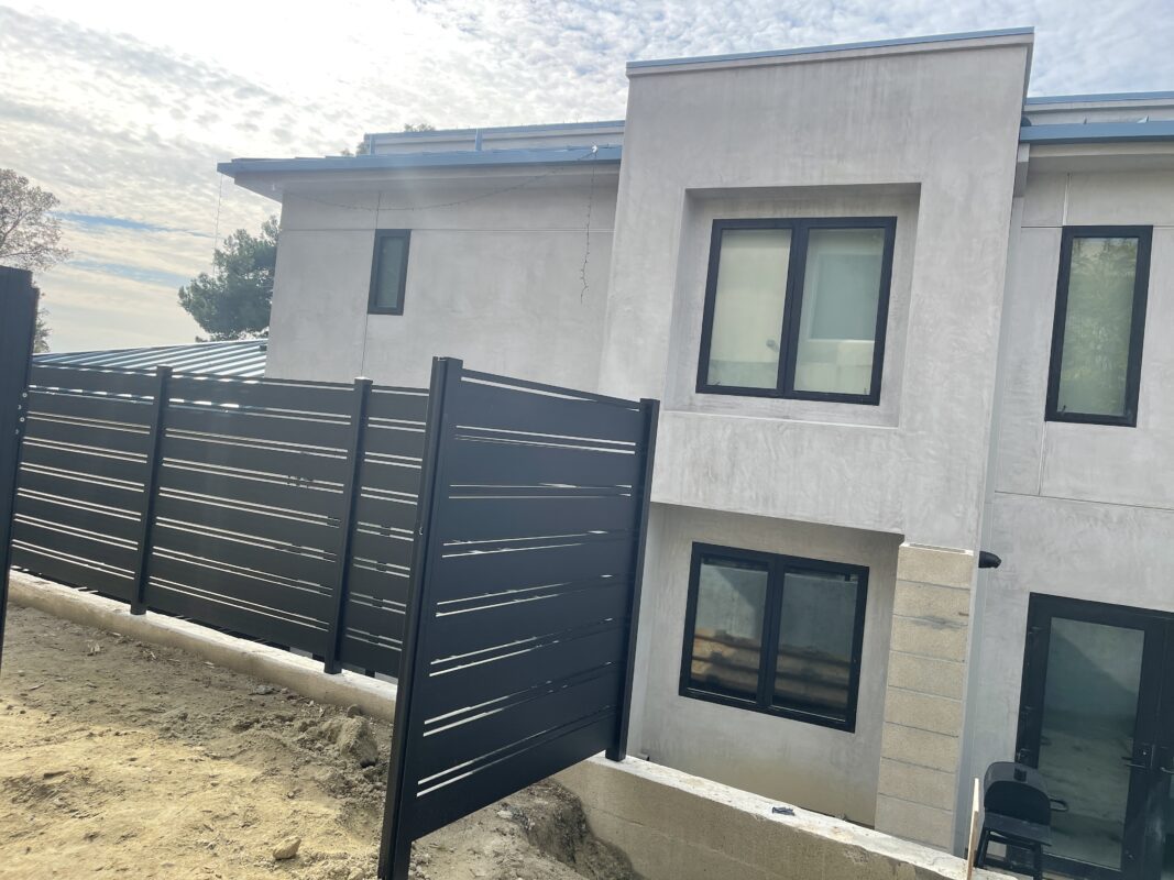 Black aluminum fence installed beside a modern home in Laguna Beach.