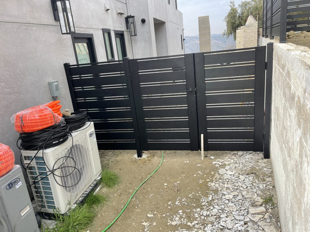 Modern black perimeter fence installation in Laguna Beach, enhancing security and aesthetics.