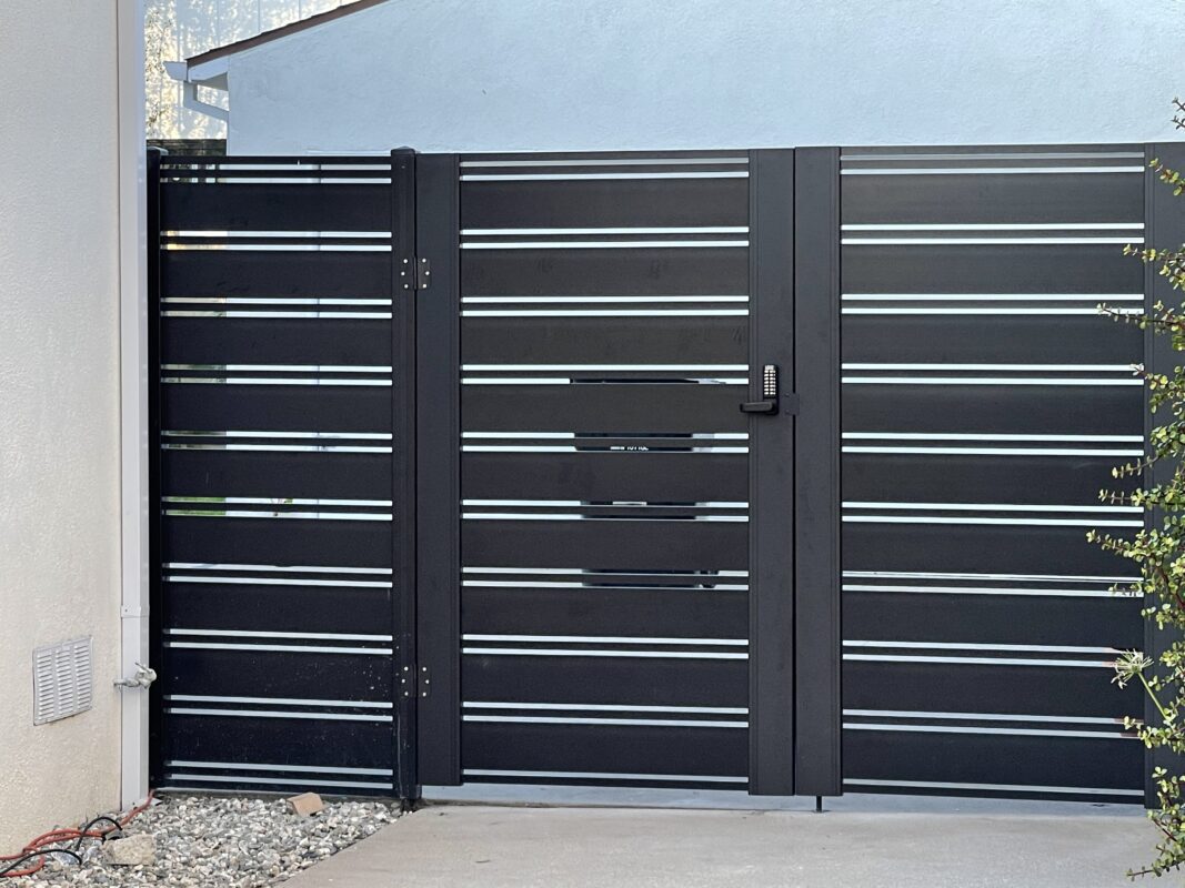 Black aluminum double swing gates installed, showcasing modern design and durability.