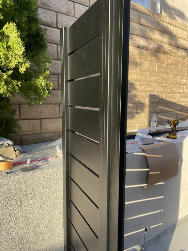 Black aluminum side yard gate in Sun Valley, CA, showcasing modern design and stability.
