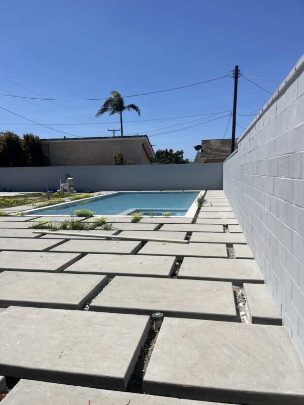 A view of a newly installed fence surrounding a swimming pool area with clean lines.