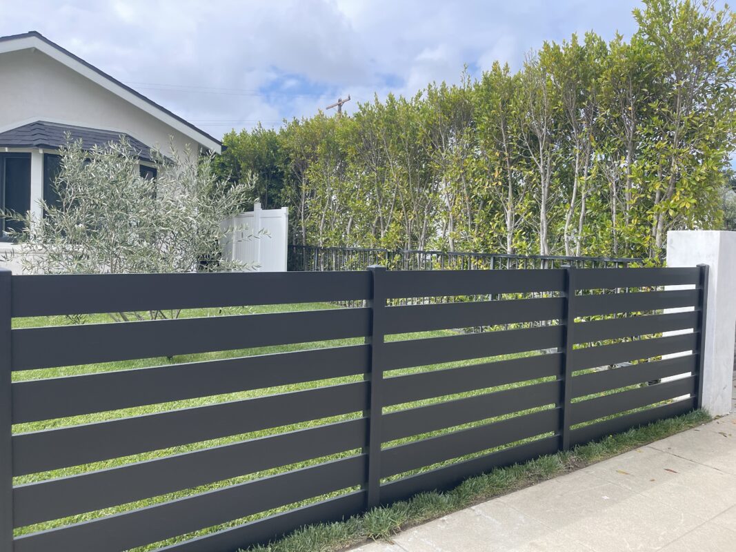 Modern black aluminum fence enhancing security and aesthetics in North Hollywood.