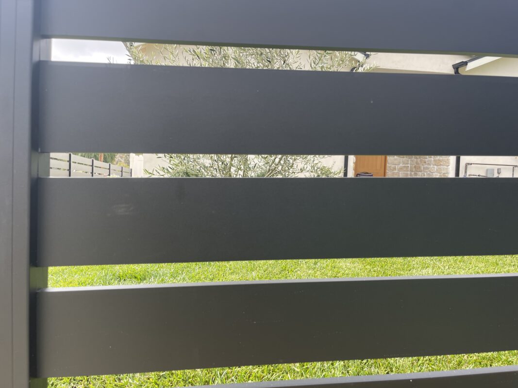 Modern black aluminum fence with sleek design in a North Hollywood front yard.