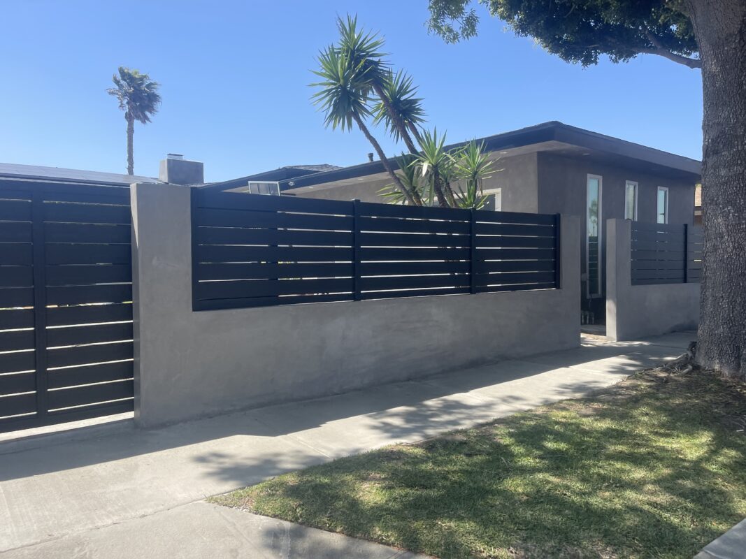 Modern black aluminum fence and gate enhancing privacy for a Los Angeles property.