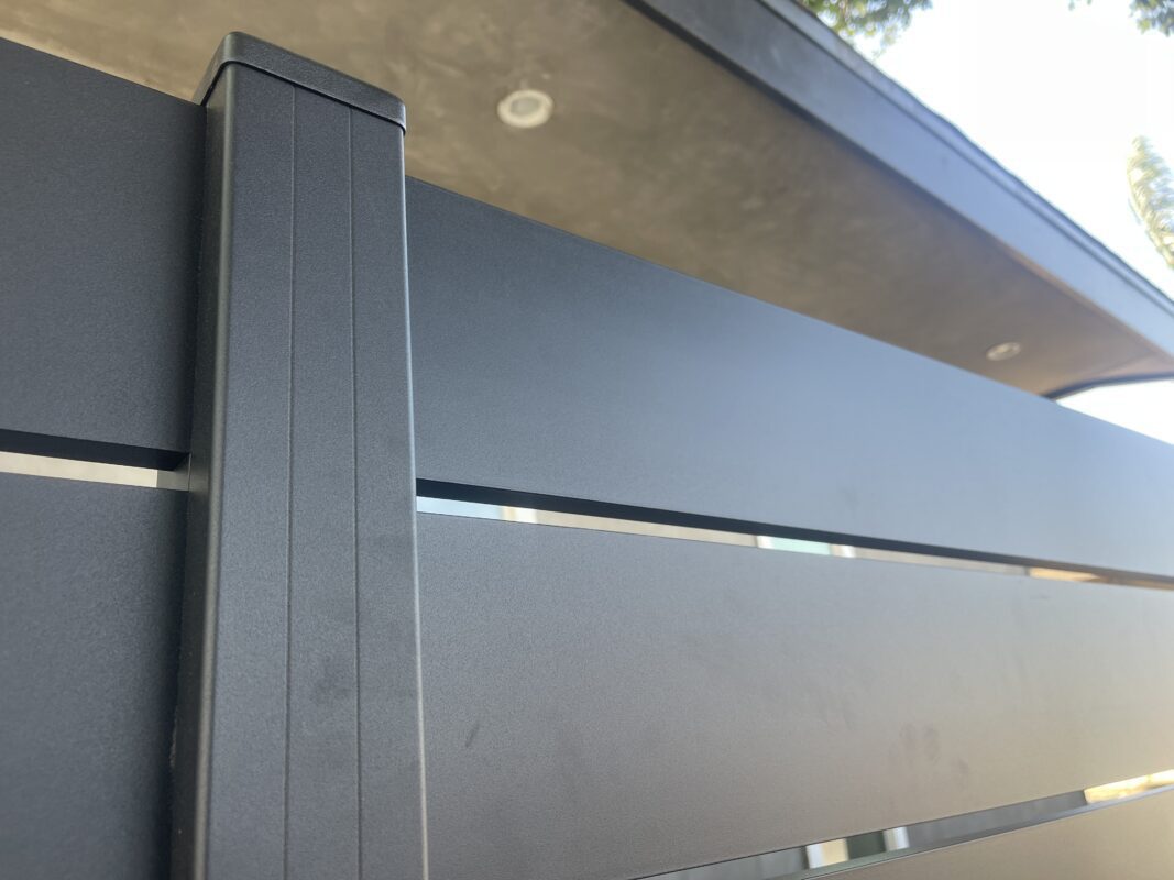 Close-up of a sleek black aluminum fence panel showcasing modern design elements.