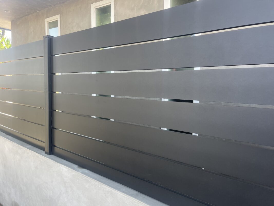 Modern black aluminum fence panels installed for privacy and security.