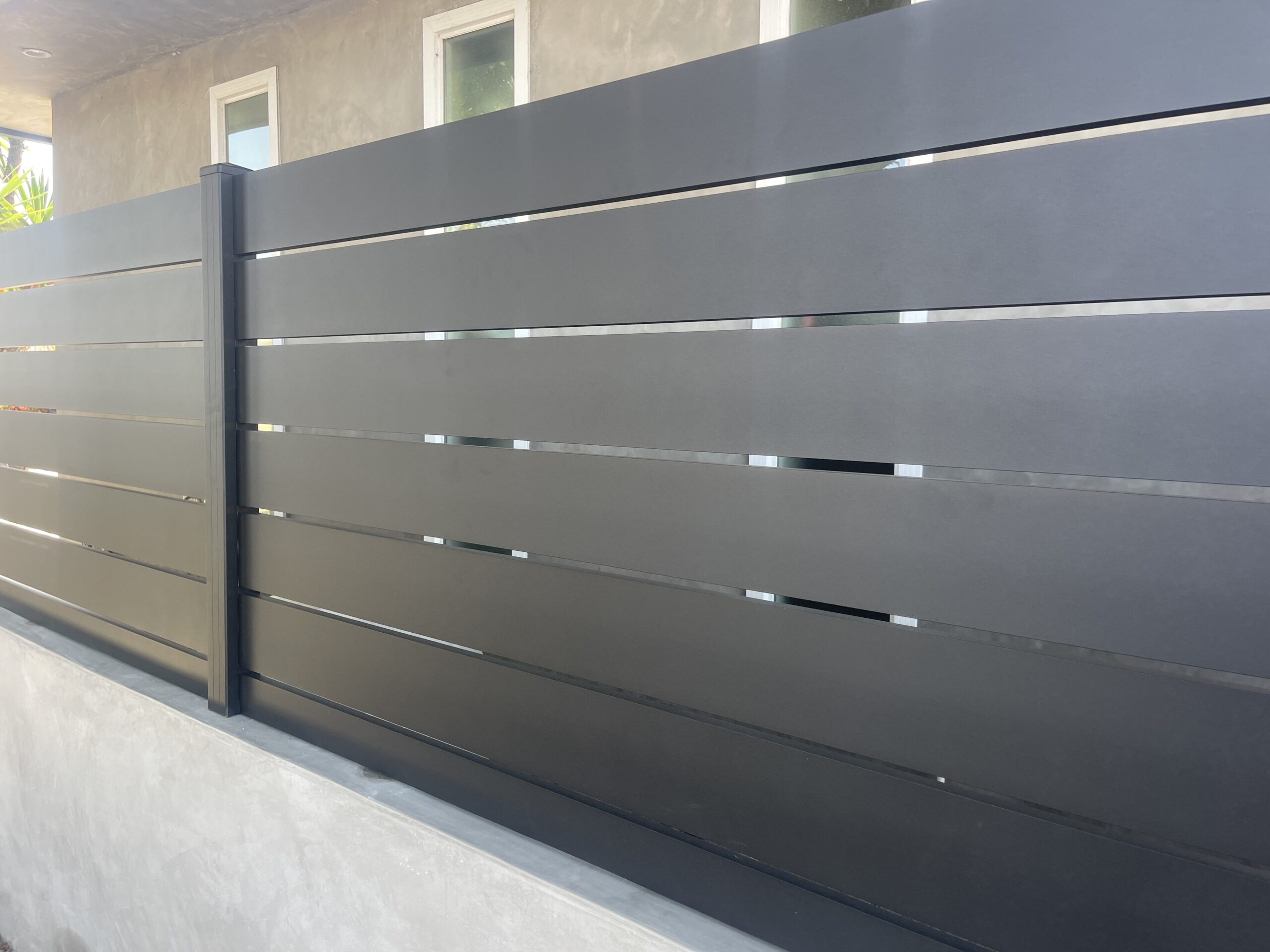 Modern black aluminum fence panels installed for privacy and security.
