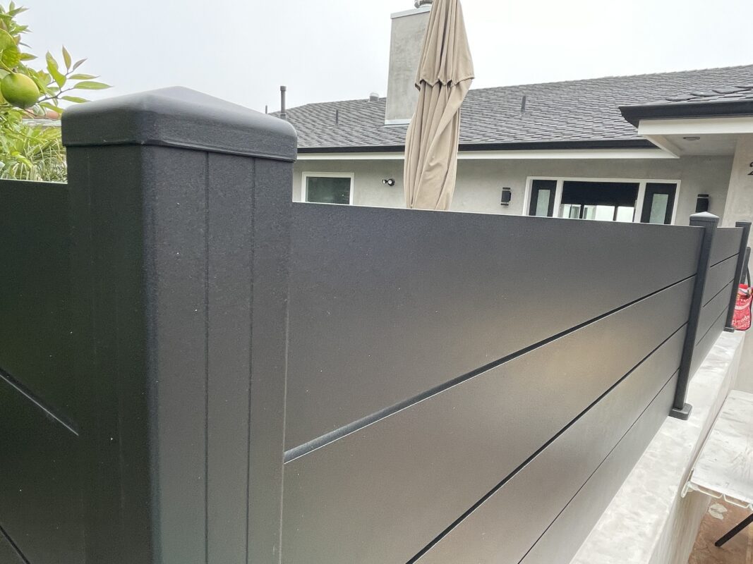 Close-up of a modern black fence with a sleek design, showcasing its elegant top profile.