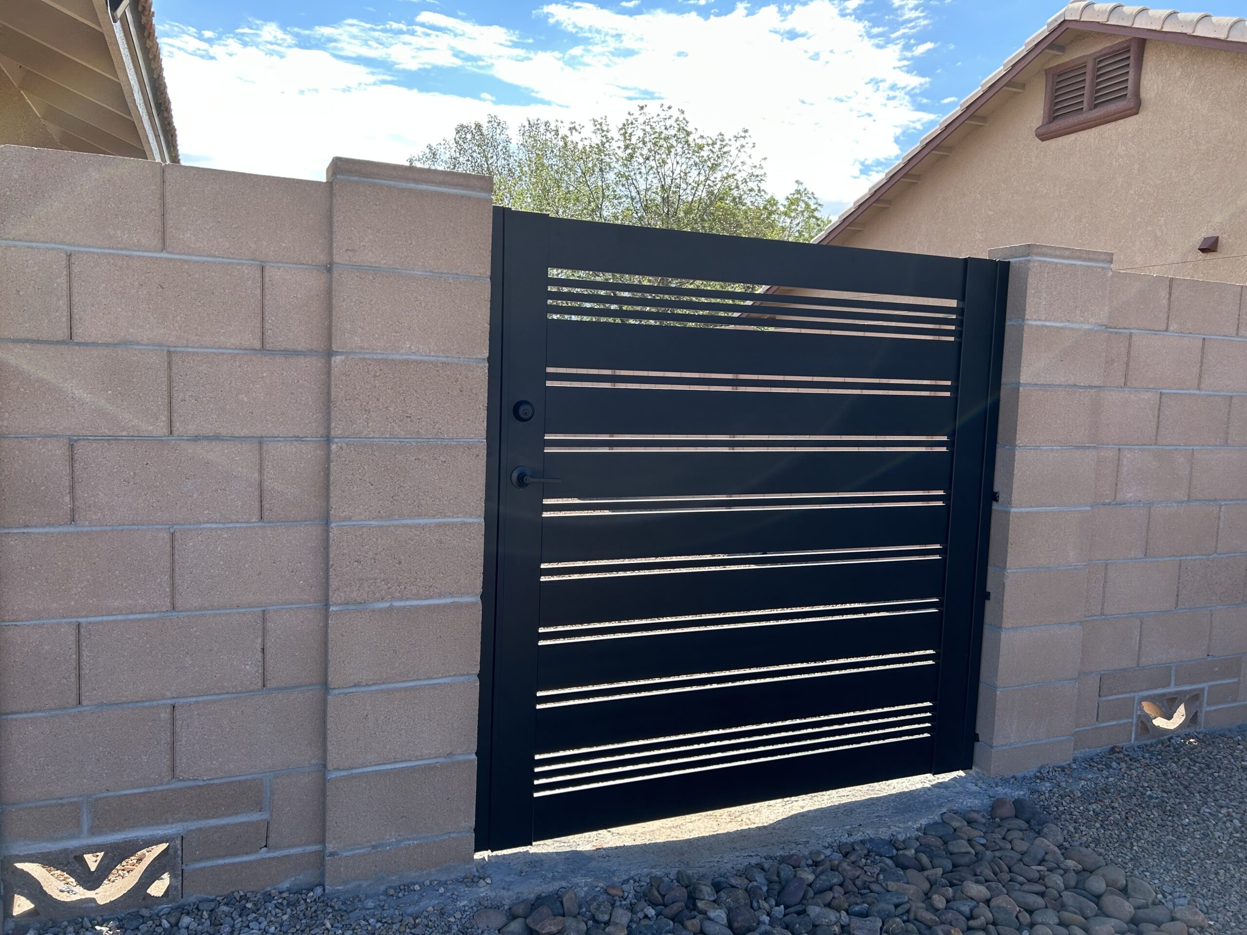 Modern matte black aluminum gate installed in Sierra Vista, AZ, with slat design.
